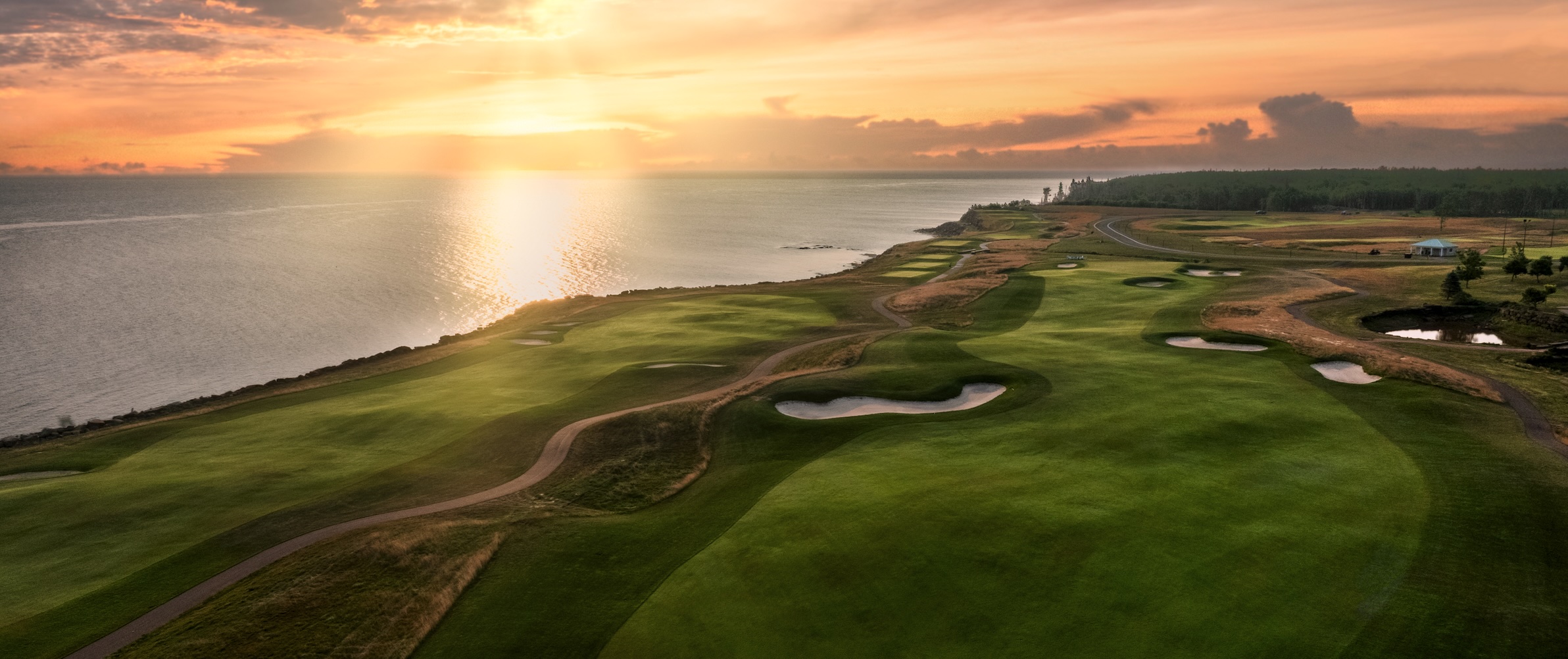 Fox Harb'r Resort — oceanside course glowing under a Northumberland Strait sunset